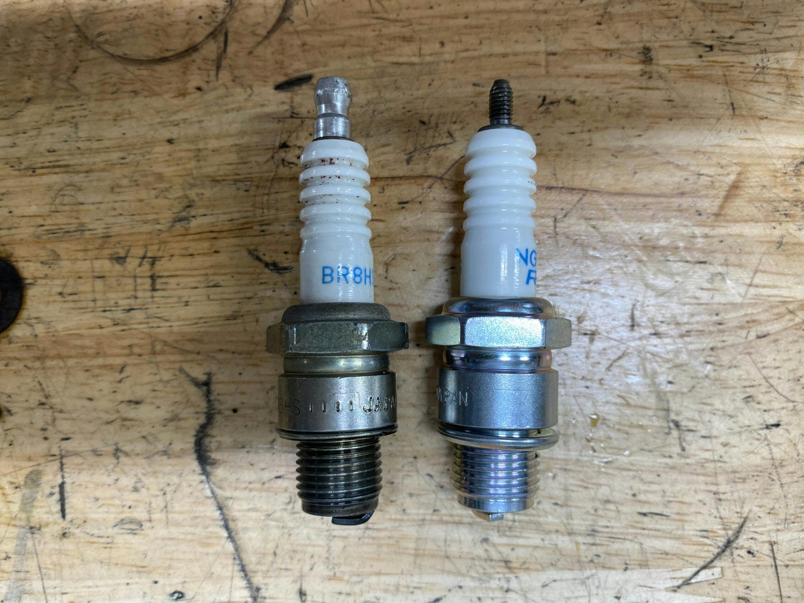 Used and new spark plug for sno runner