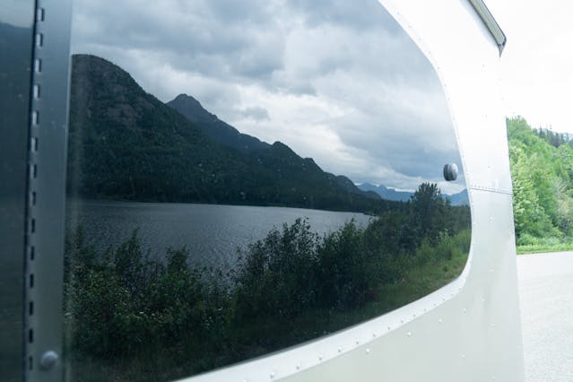 Bronco Airstream Alaska Road Trip window reflection of mountains