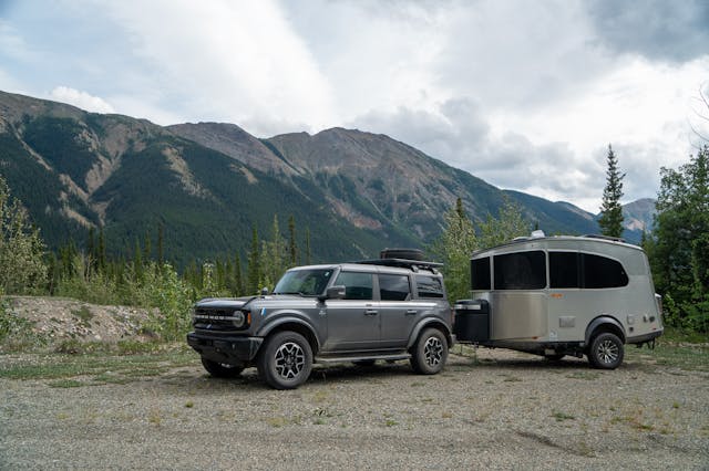 Bronco Airstream Alaska Road Trip Side profile wooded mountains