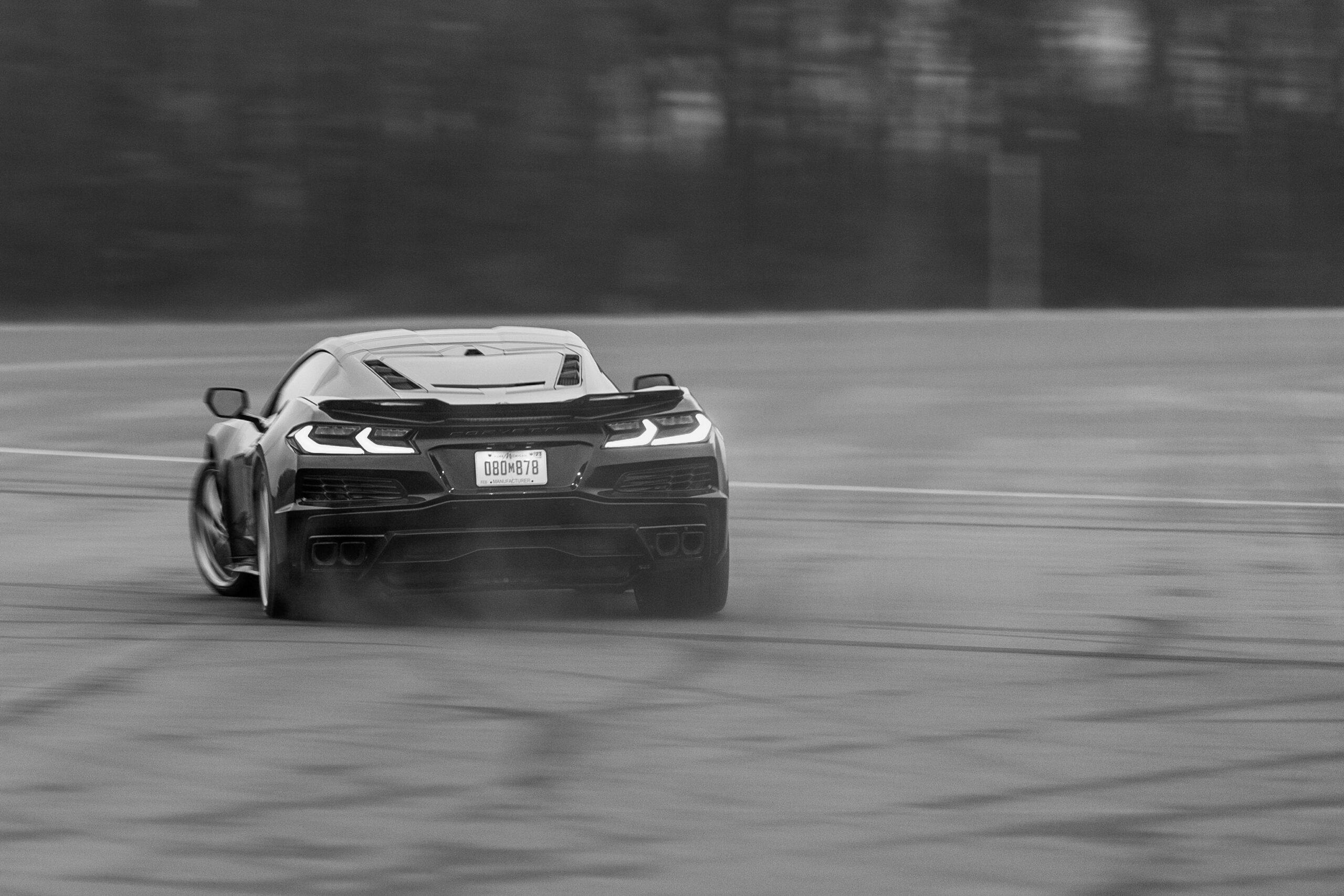 New Corvette E-Ray hybrid driving action rear black white