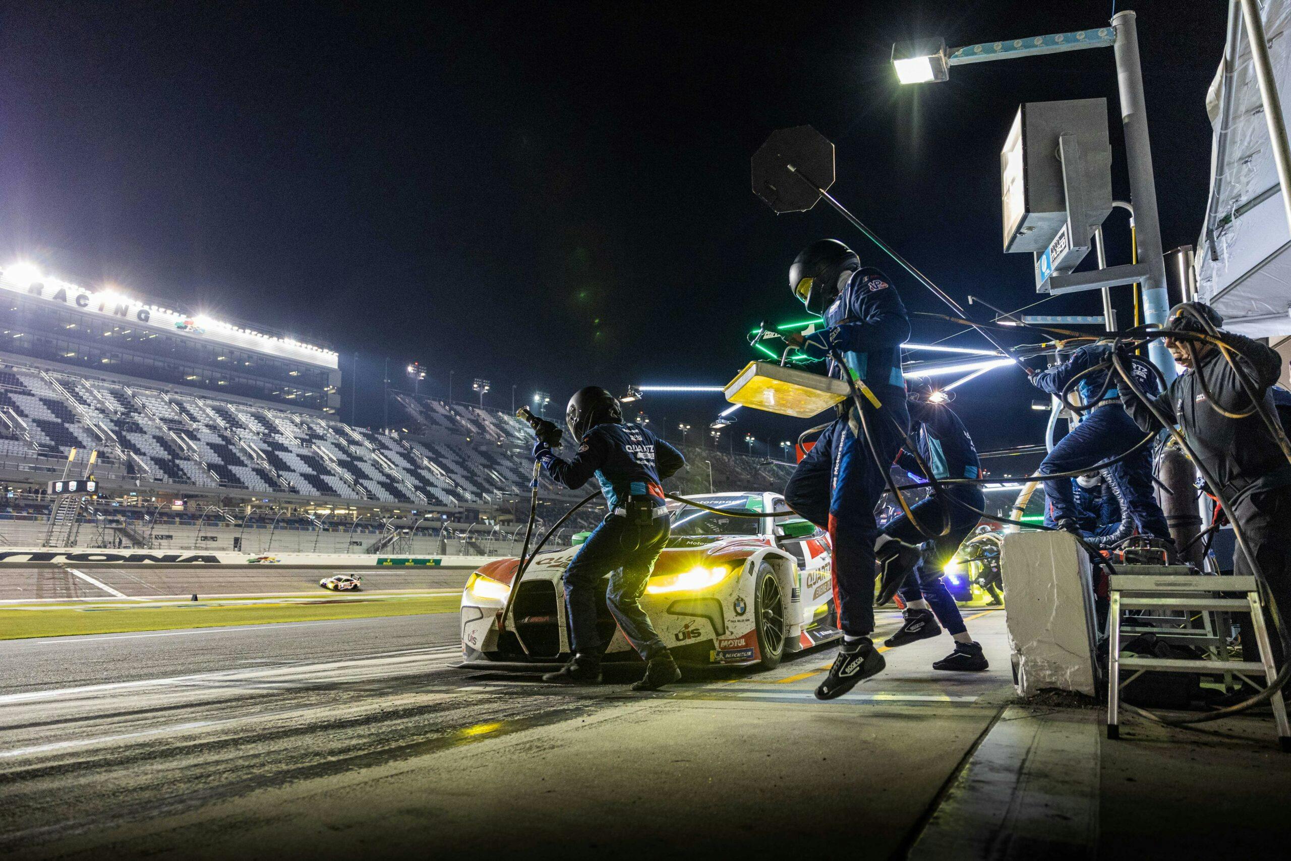 The Paul Miller racing team jumps over the wall to service the BMW M4 GT3 during the 2023 Rolex 24 at Daytona
