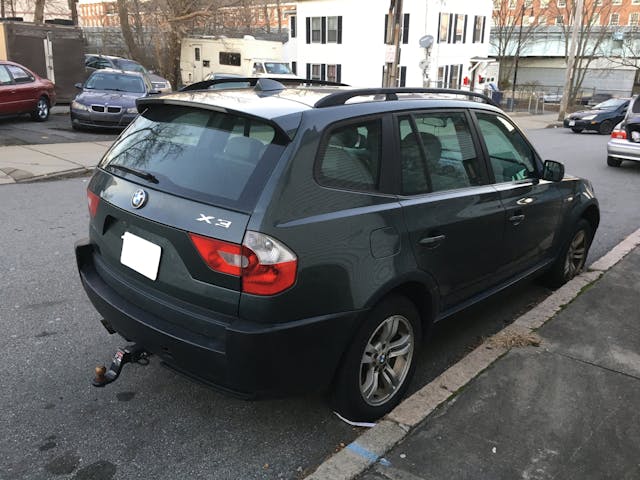 BMW X3 SUV rear three quarter street parked