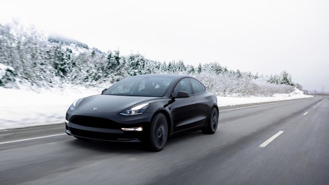Tesla-Model-3-winter-weather front three quarter driving action