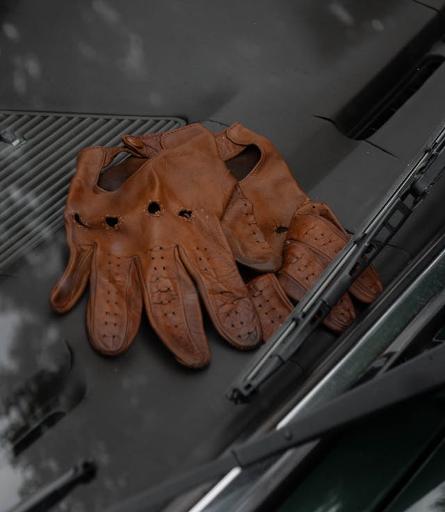 driving gloves resting on car dash closeup