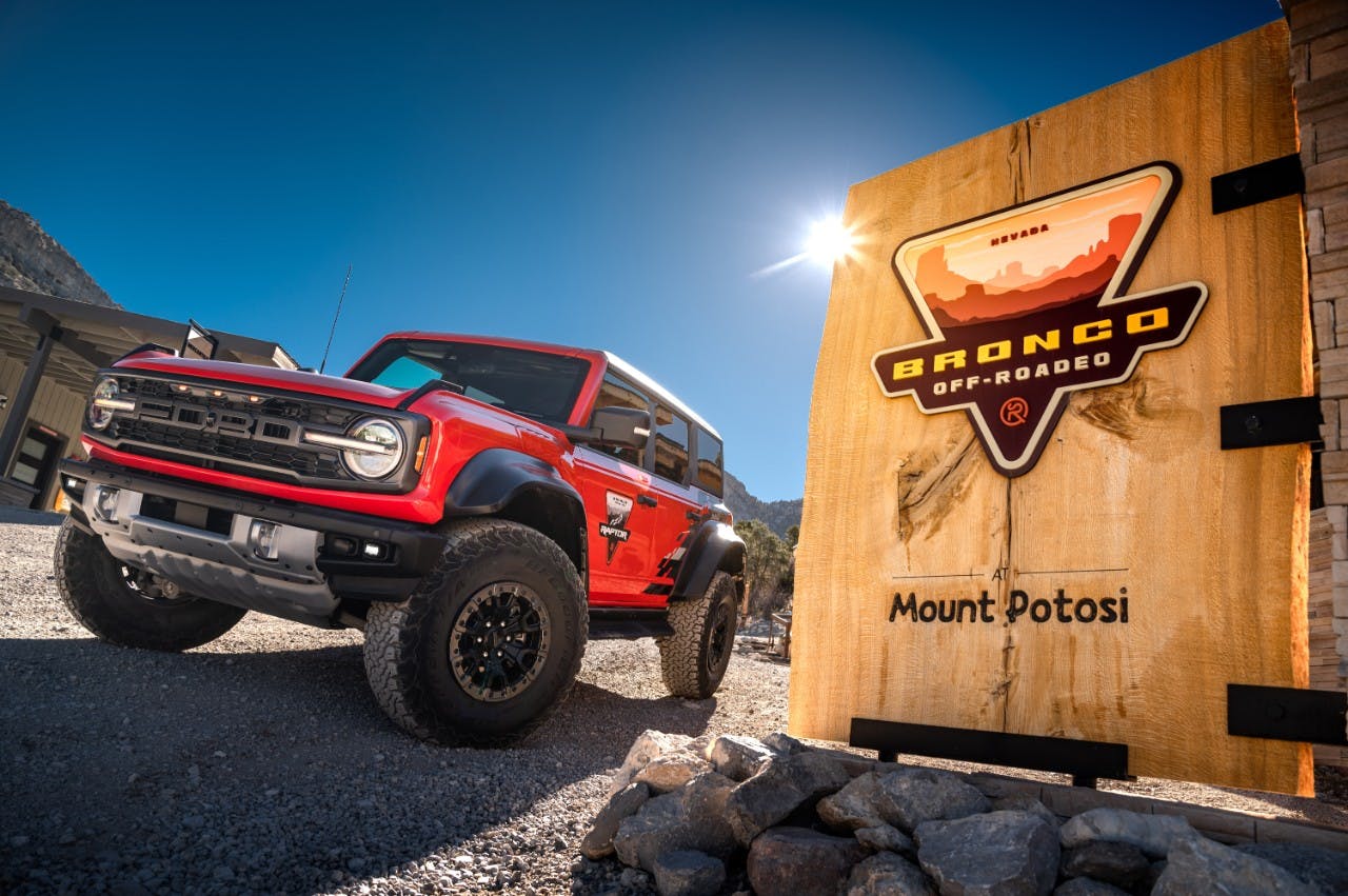 Ford Bronco Raptor Off-Roadeo exterior front three quarter next to small Mount Potosi sign