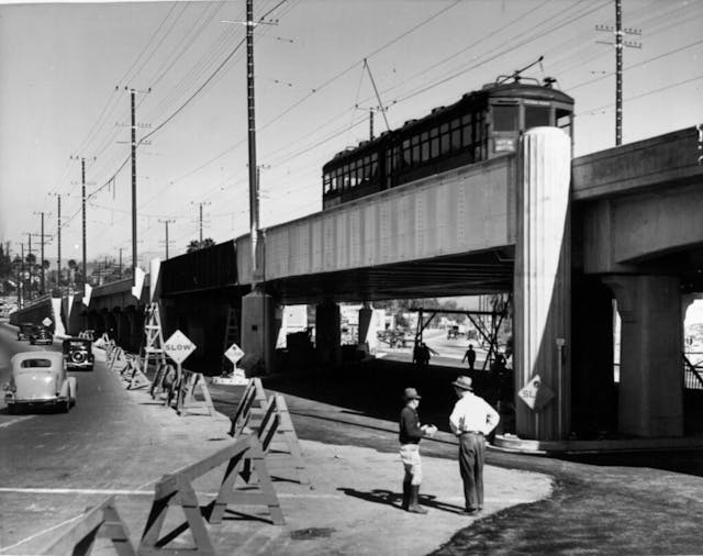 Wooden barriers wall off the viaduct project at the intersection of Huntington and Soto in Los Angeles California 1937