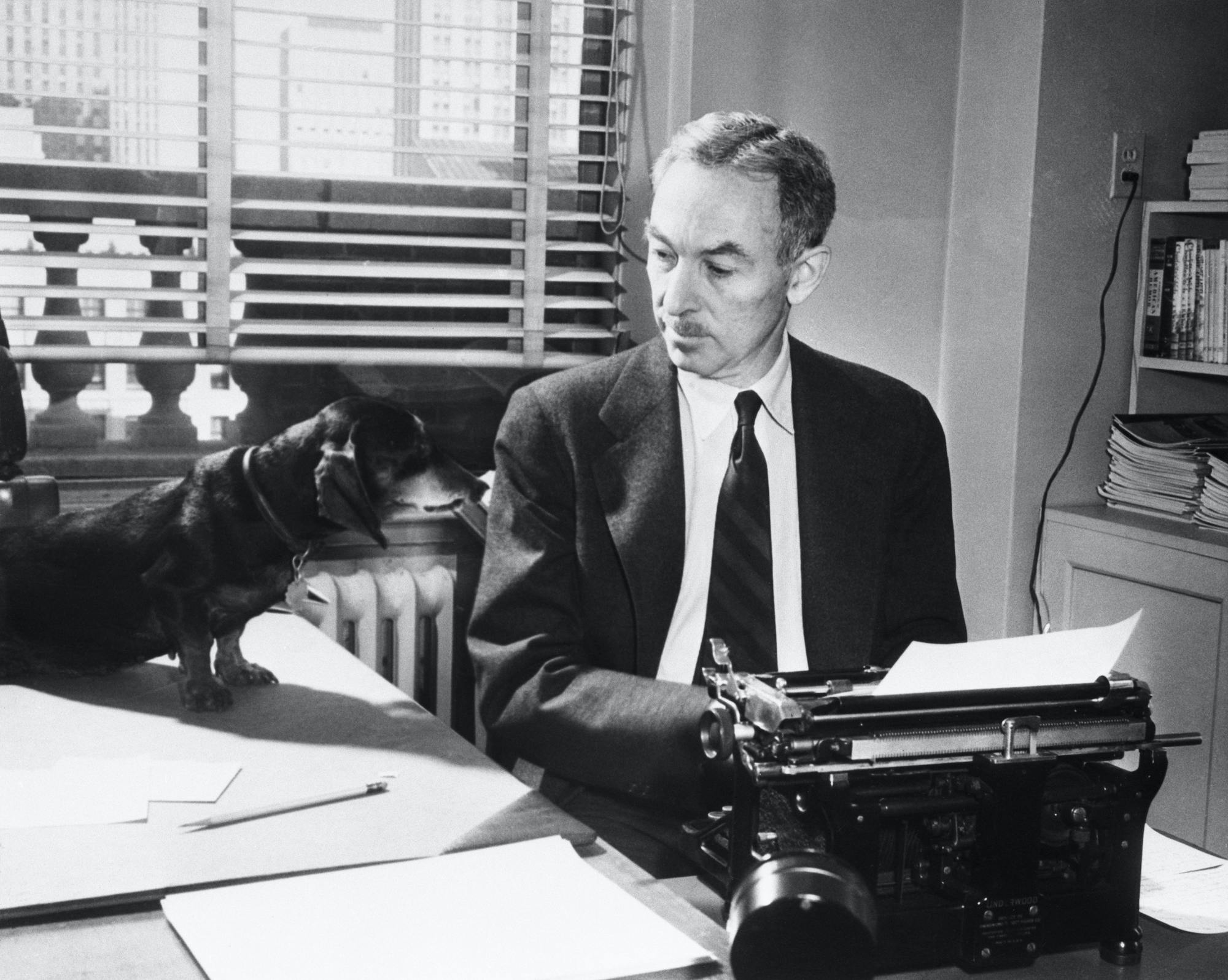 E.B. White at Typewriter with Dog Writer typing with dog