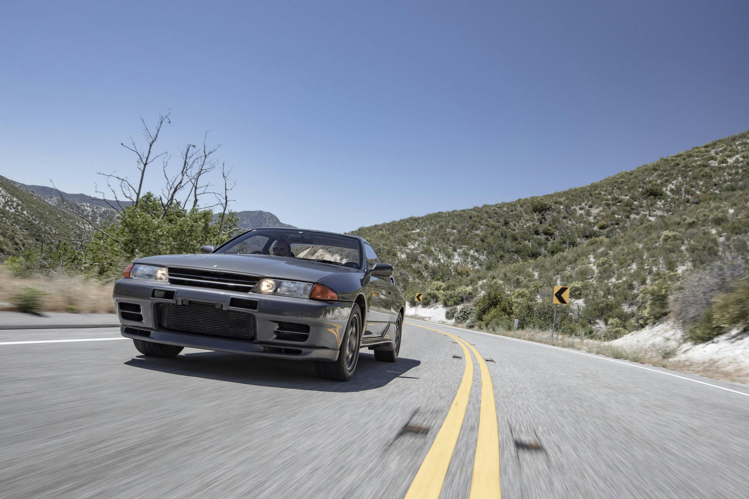 Nissan Skyline R32 GT-R front three quarter driving action