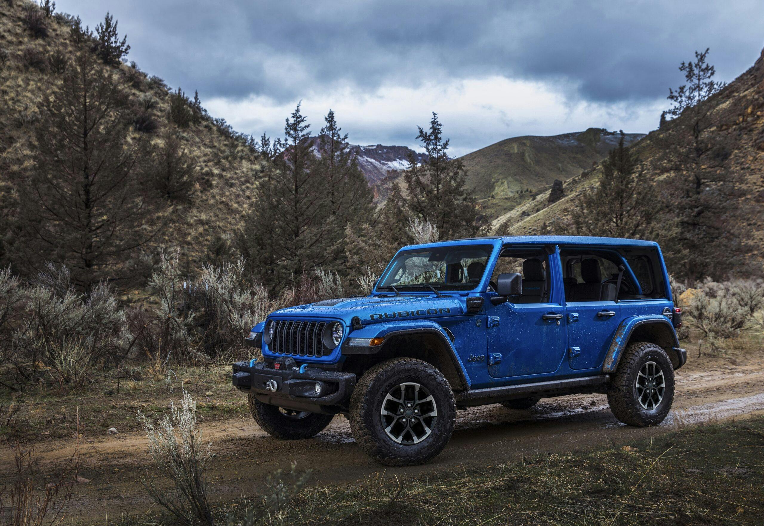 2024 Jeep Wrangler Rubicon X 4xe exterior front three quarter blue on trail