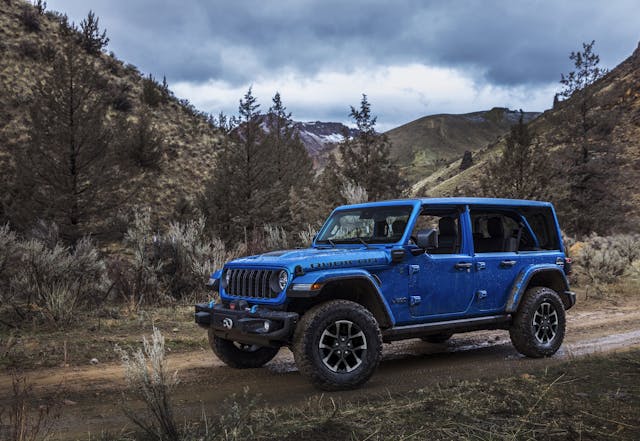 2024 Jeep Wrangler Rubicon X 4xe exterior front three quarter blue on trail