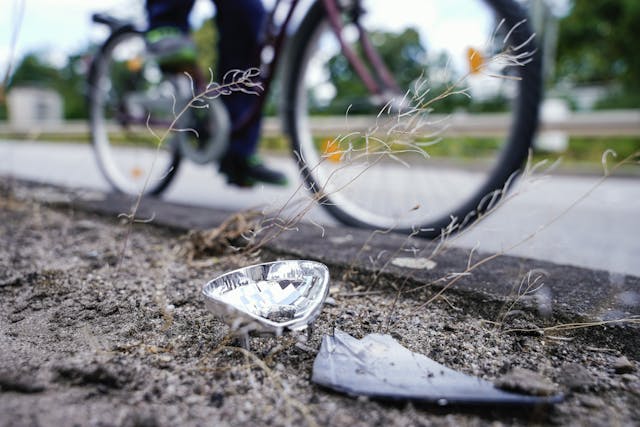 Driver drives into group of cyclists reflector damage part broken closeup detail