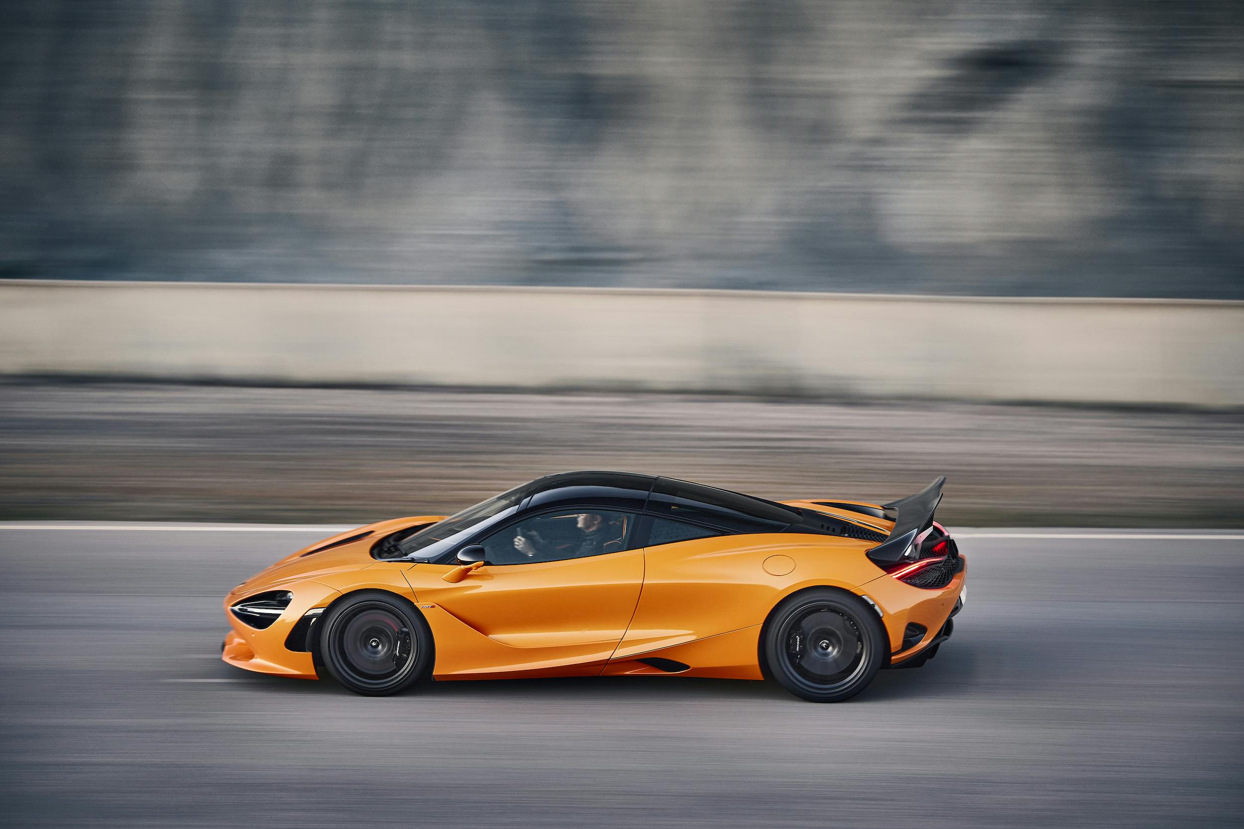 McLaren 750S Coupe side view high angle dynamic driving action