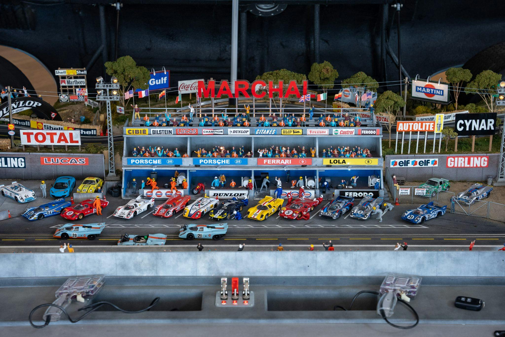 Porsche 917 slot cars Le Mans track pit lane stands full