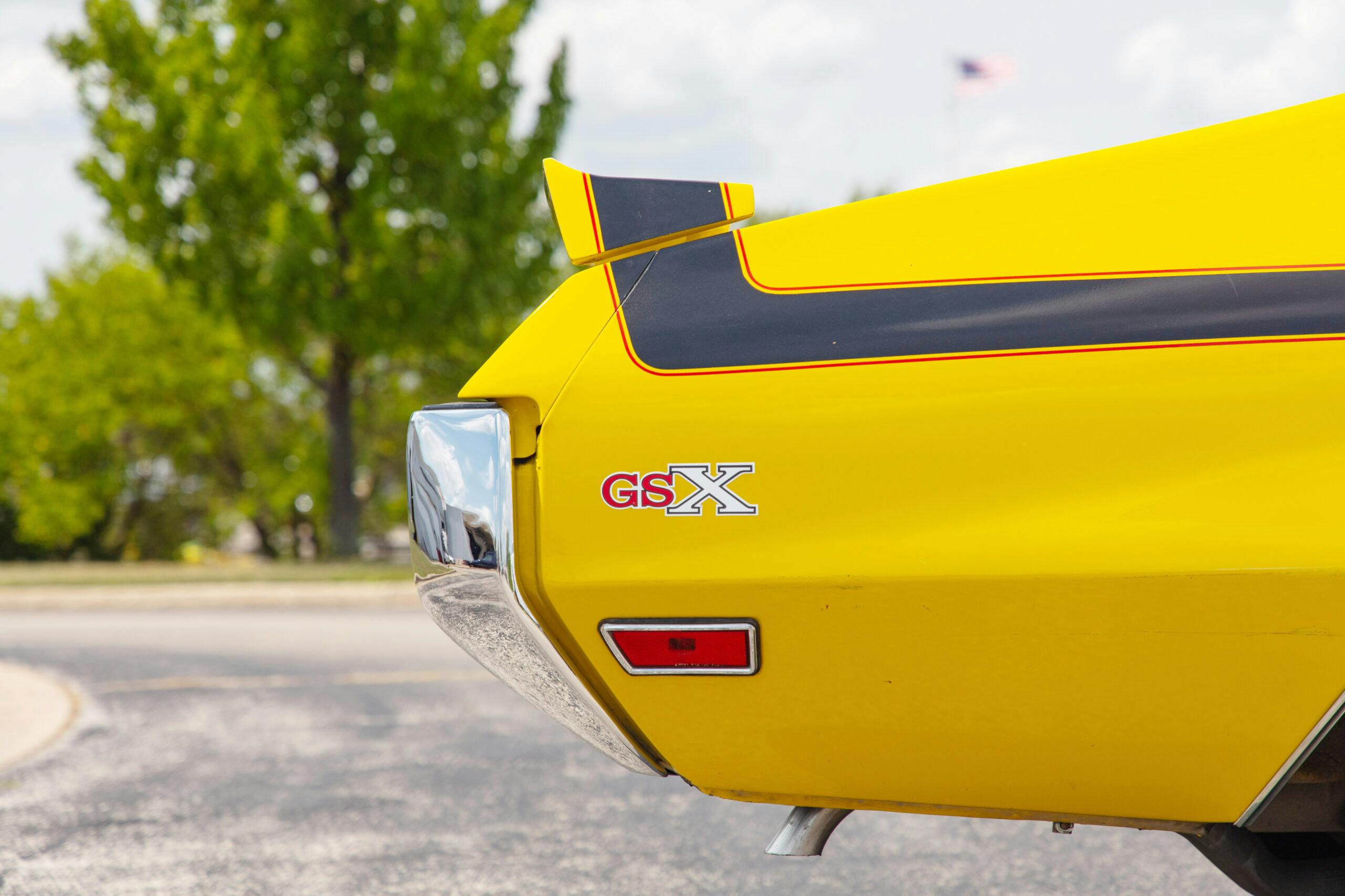 Buick GSX yellow high impact color rear end side profile