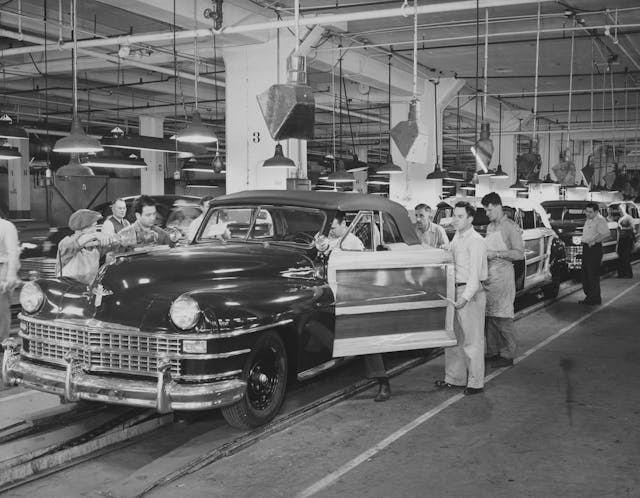 Workers around Chrysler New Yorker Town and Country station wagon