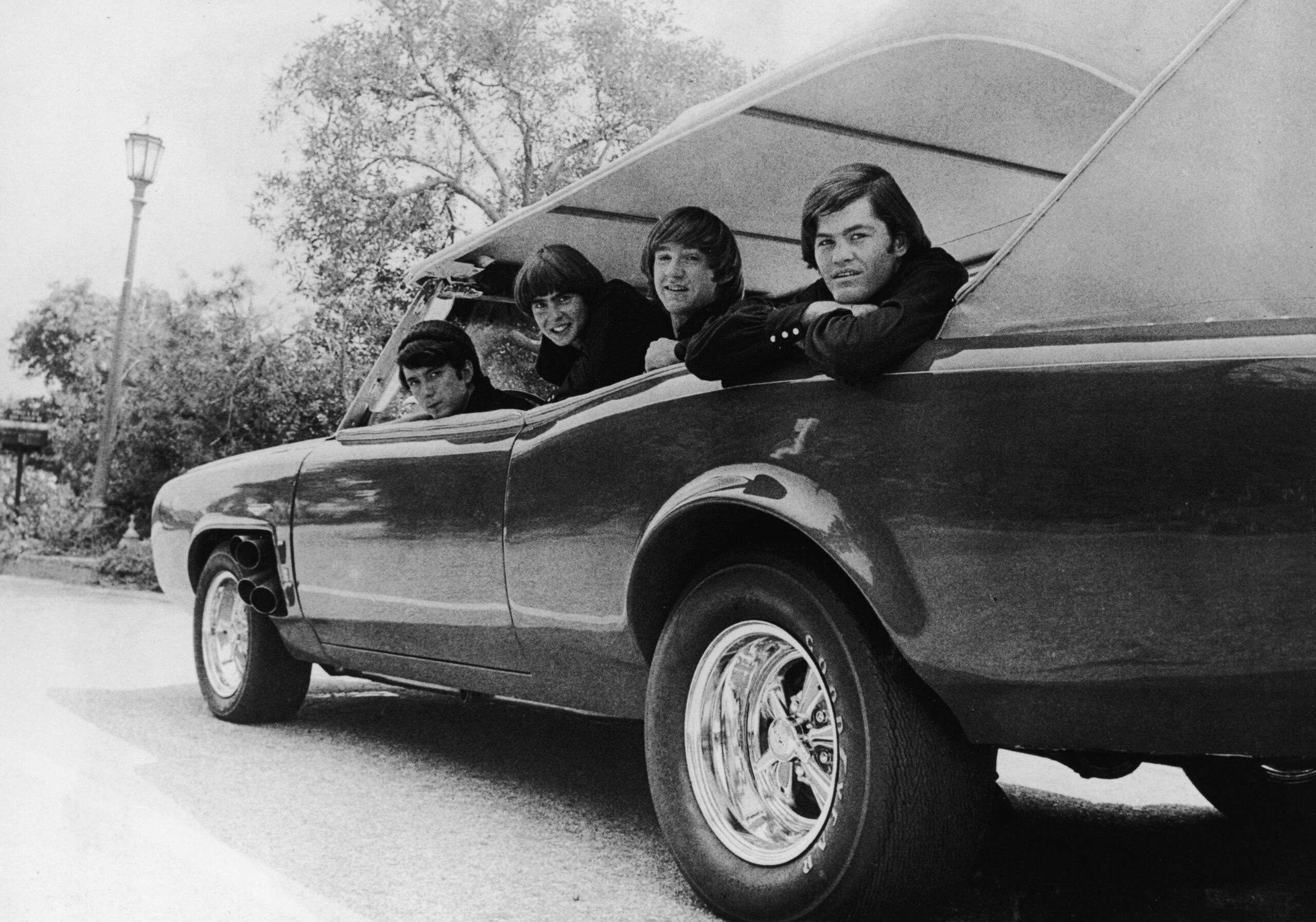 Four Monkees in monkeemobile