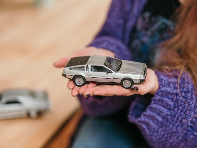 Kat DeLorean holding model car detail