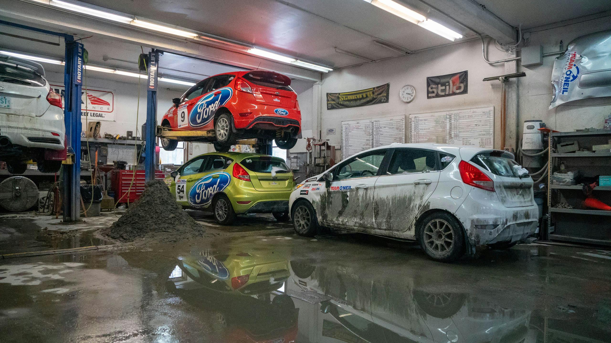 Team O'Neil rally school Ford Fiestas in service garage pile of mud