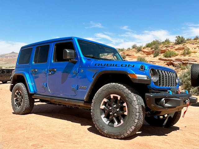 2024 Jeep Wrangler Rubicon 4xe exterior front three quarter blue in rocks