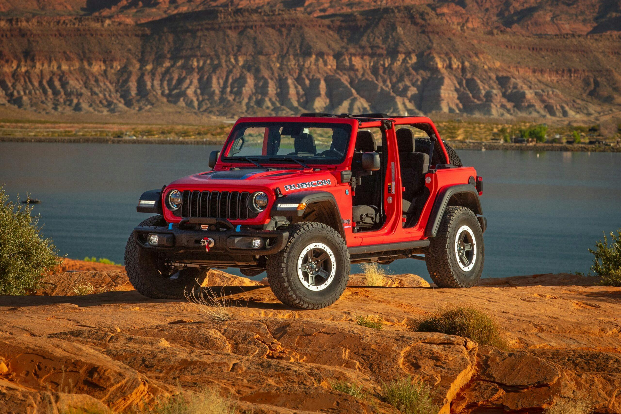 2024 Jeep Wrangler Rubicon 4xe exterior front three quarter on rocks red with doors off