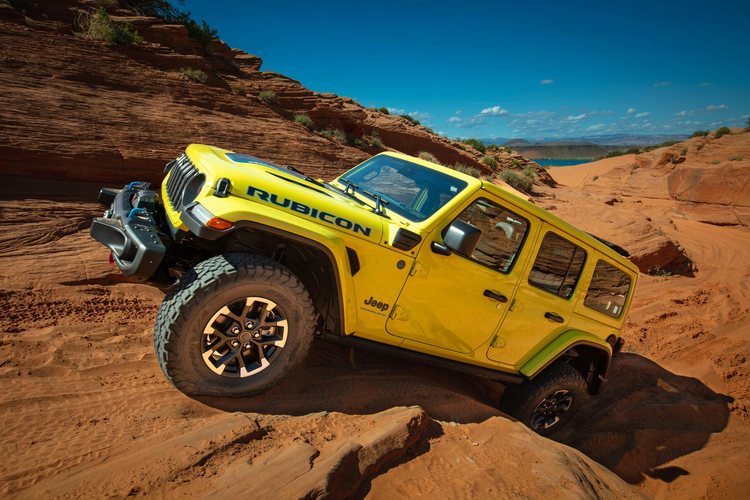 2024 Jeep Wrangler Rubicon 4xe exterior front three quarter climbing rocks yellow