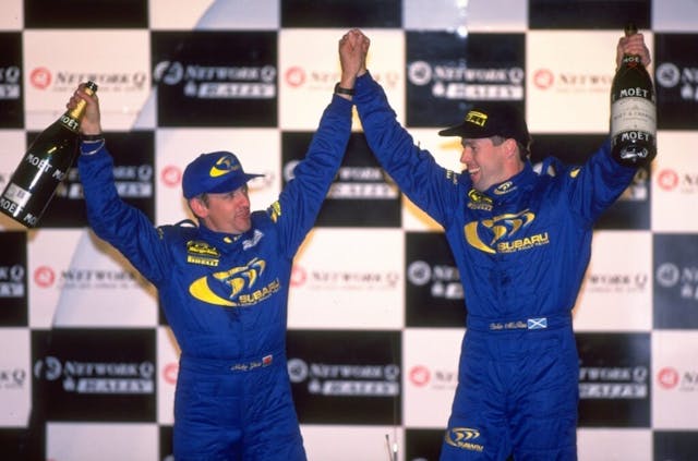 Colin McRae (left) and Nicky Grist celebrate on the winners podium after their victory in England