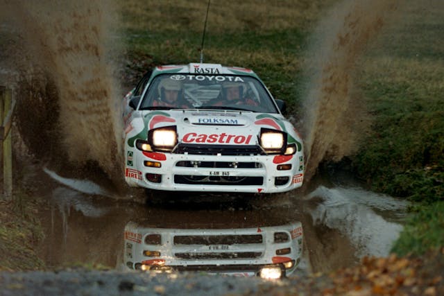 Juha Kankkunen glides over a puddle rally