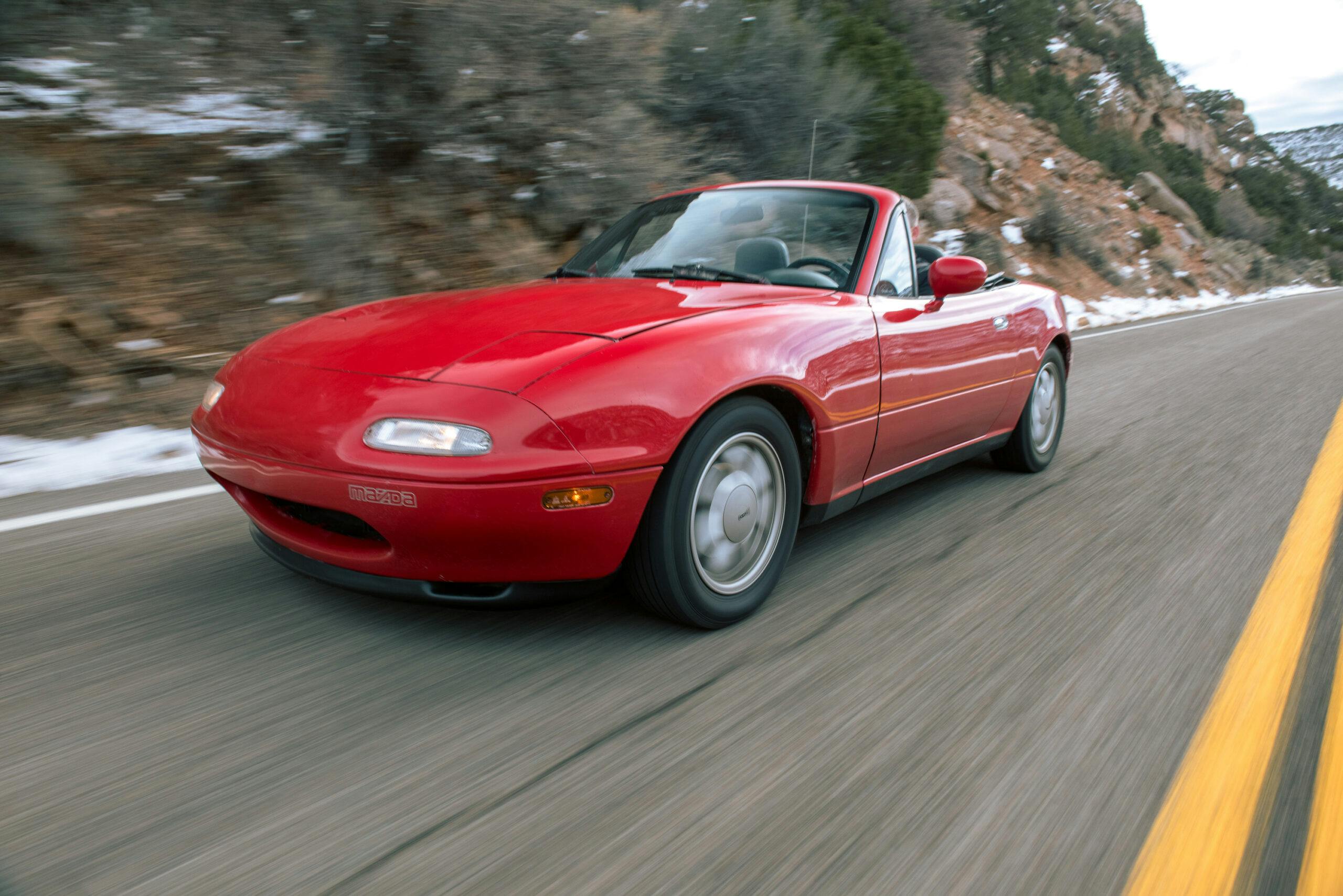 Flyin Miata NA red front three quarter driving action