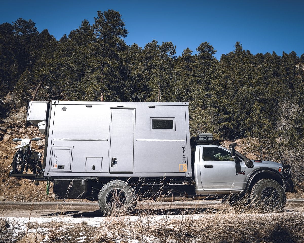 AEV x Bliss Mobil Prospector XL 550 exterior side profile low parked along snowy trail