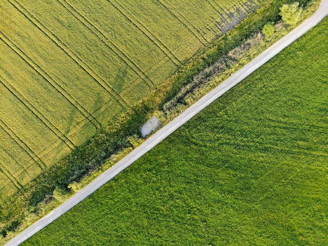 open road farm fields divide aerial