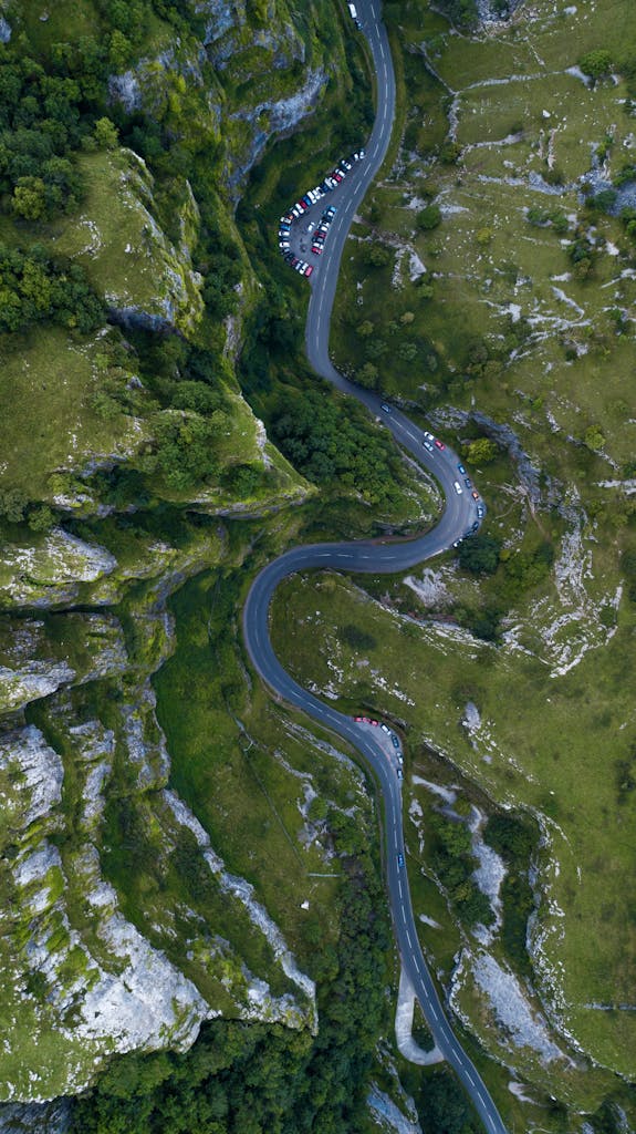 open road winding mountain pass aerial overhead