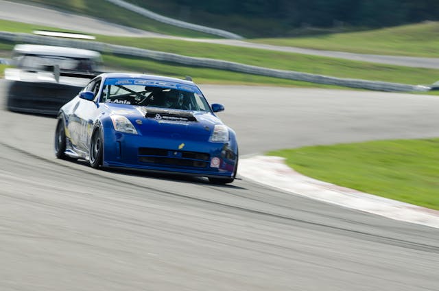Sasha Anis racing Nissan 350Z blue track action front cornering