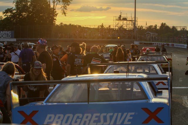 Superstar Racing Experience (SRX) cars and crowd at golden hour