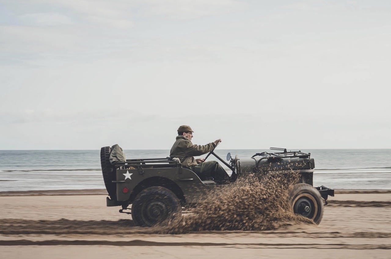 Classic Military Willys Jeep sand spit driving action
