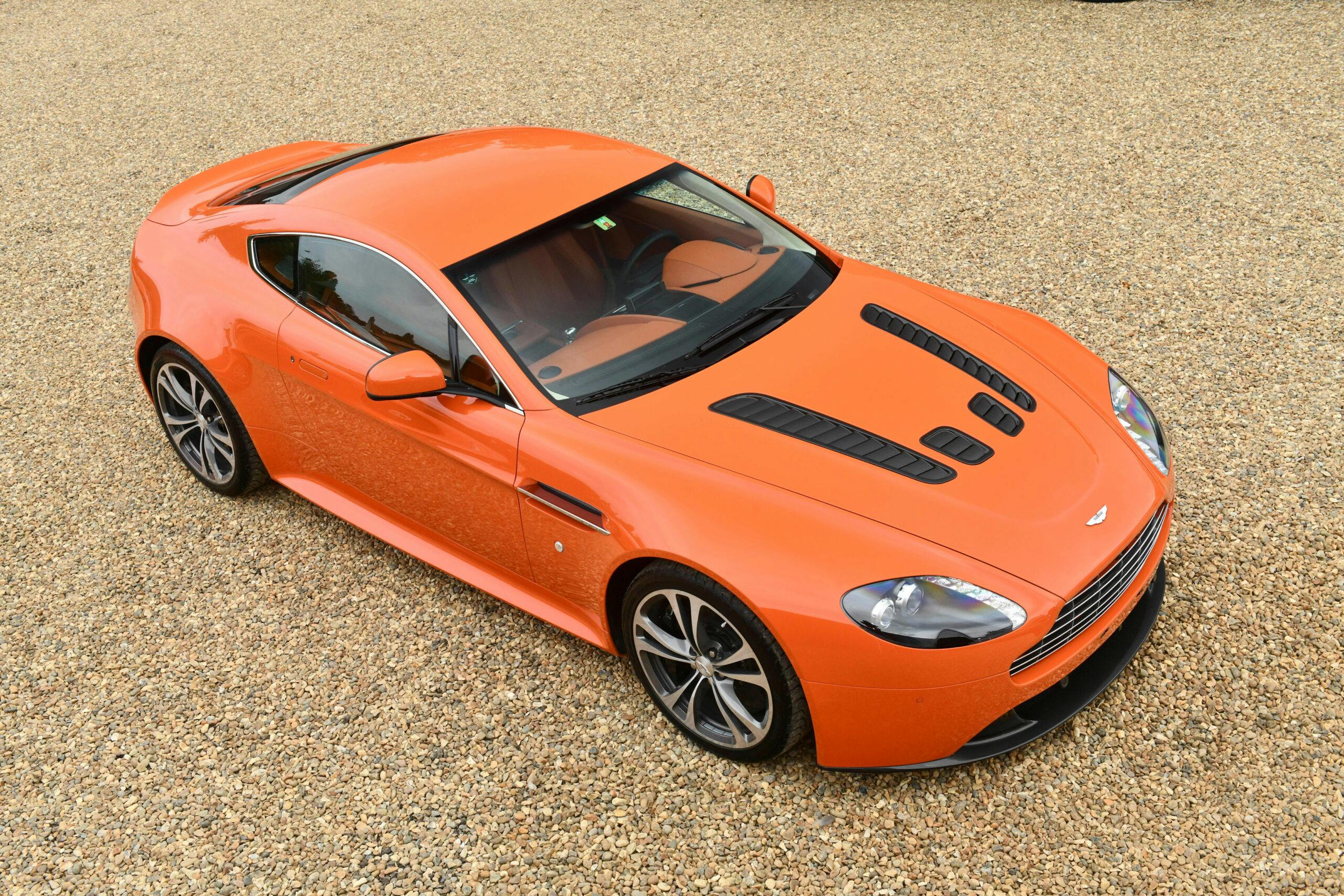 2010-Aston-Martin-V12-Vantage orange front three quarter high angle