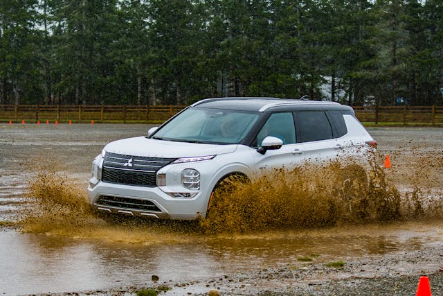 2023 Outlander PHEV silver front three quarter mud pit action