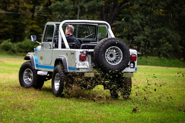 Jeep CJ-8 Scrambler rear three quarter grass ripping action 2024 bull market
