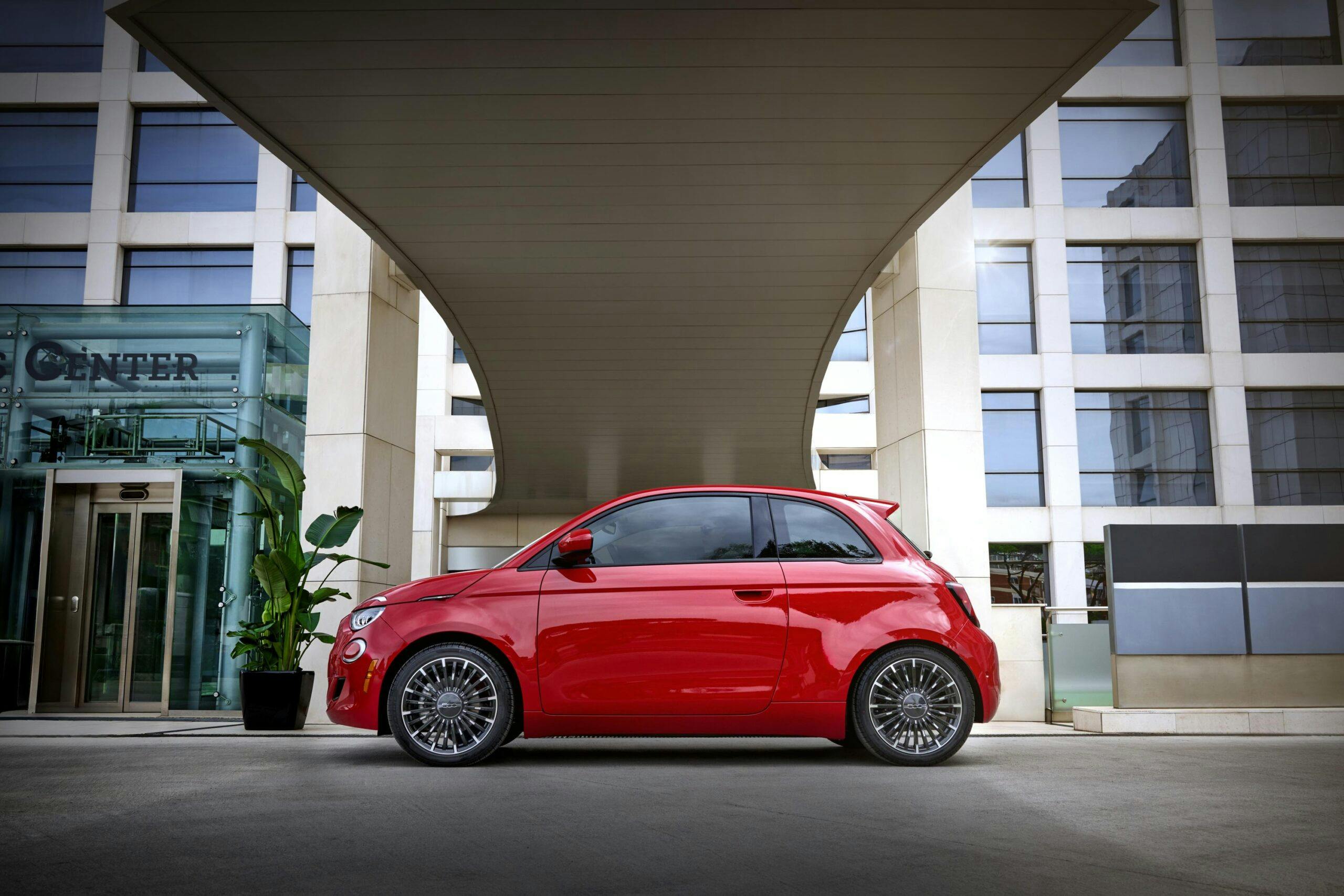 2024 Fiat 500e (RED) exterior side profile under awning