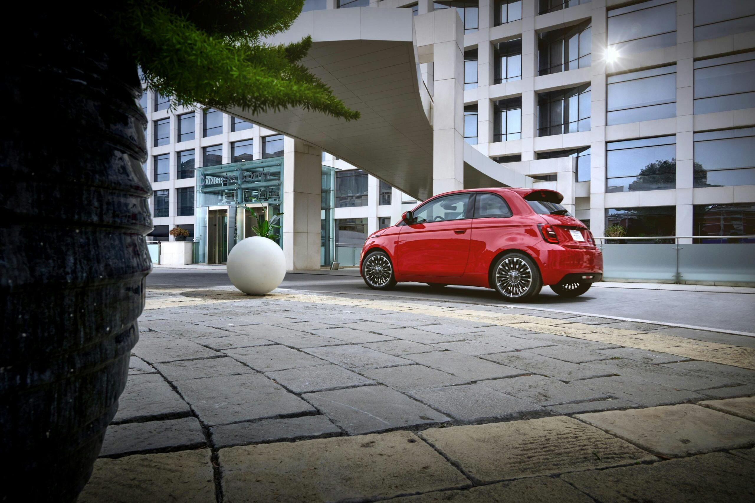 2024 Fiat 500e (RED) exterior rear three quarter under awning