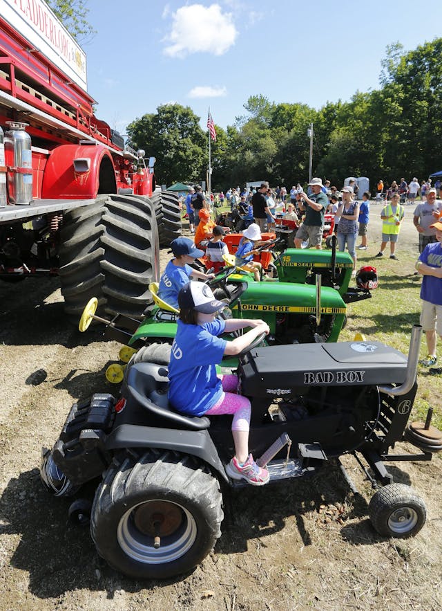 Children pick out their tractors for pull competition