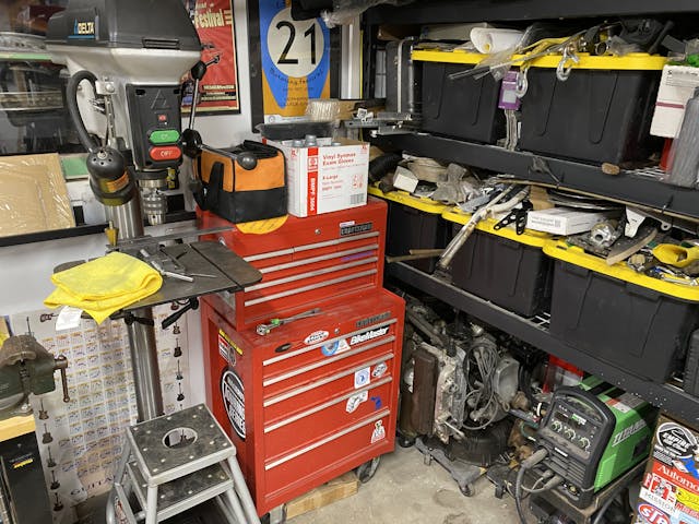 toolbox corned in cluttered shop