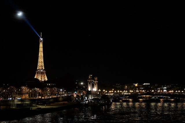 Eiffel Tower across Seine night moon illumination