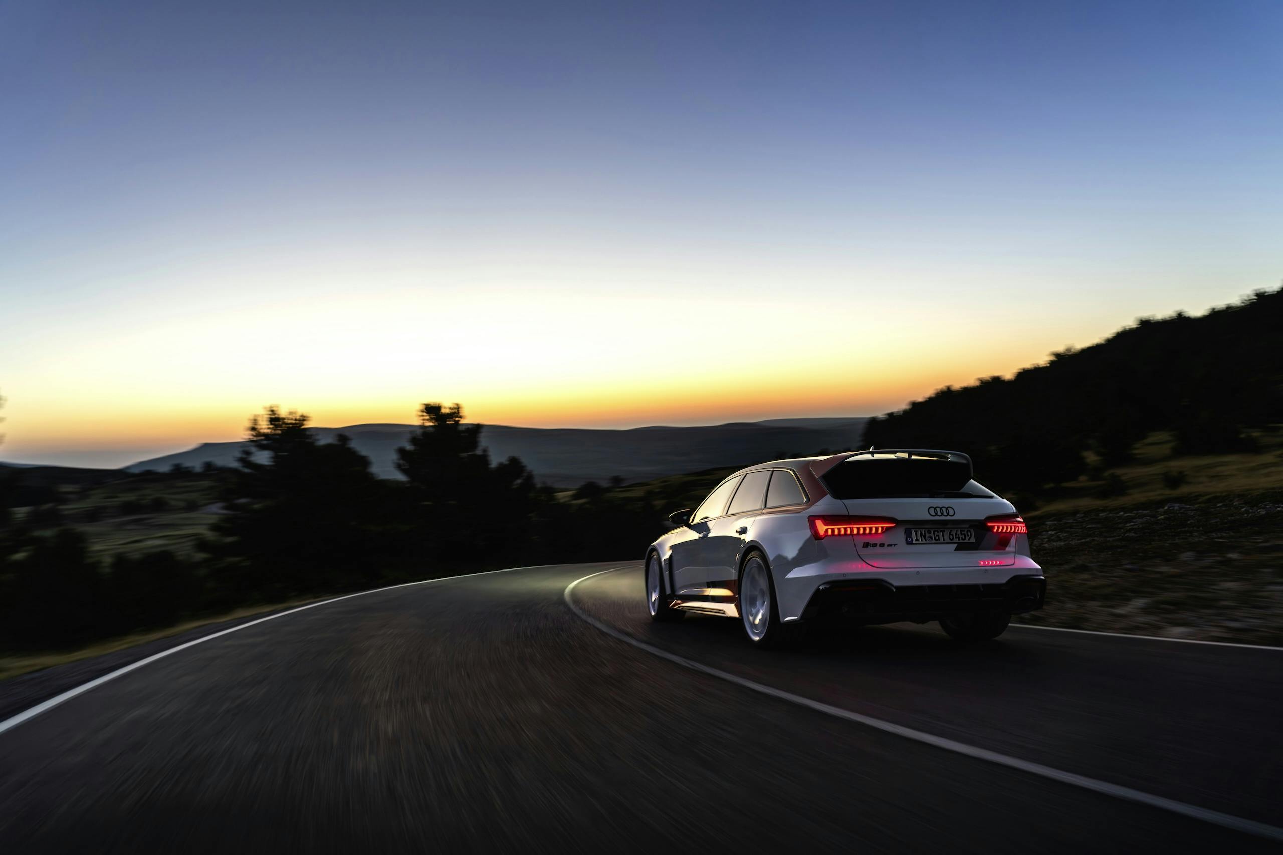 Audi RS 6 Avant GT rear three quarter dynamic action evening sky