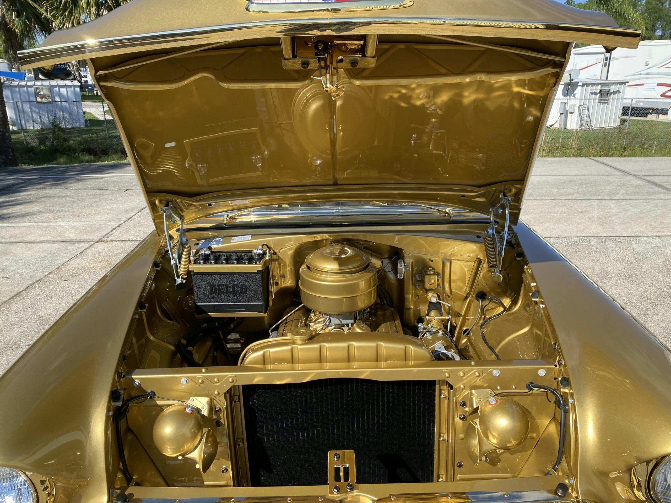 Gold-painted 1955 Chevy Bel Air two-door hardtop engine bay