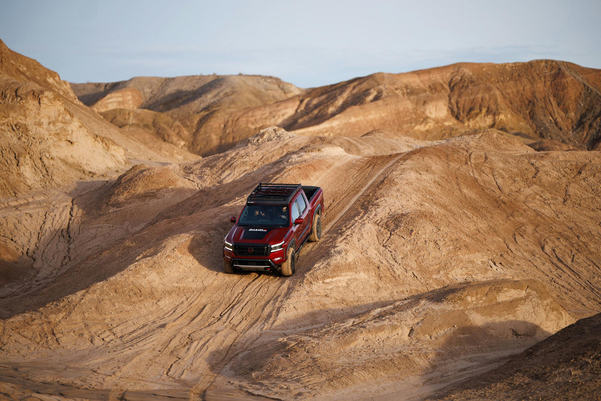 Nissan Frontier Forsberg Edition exterior demo truck descending desert hill
