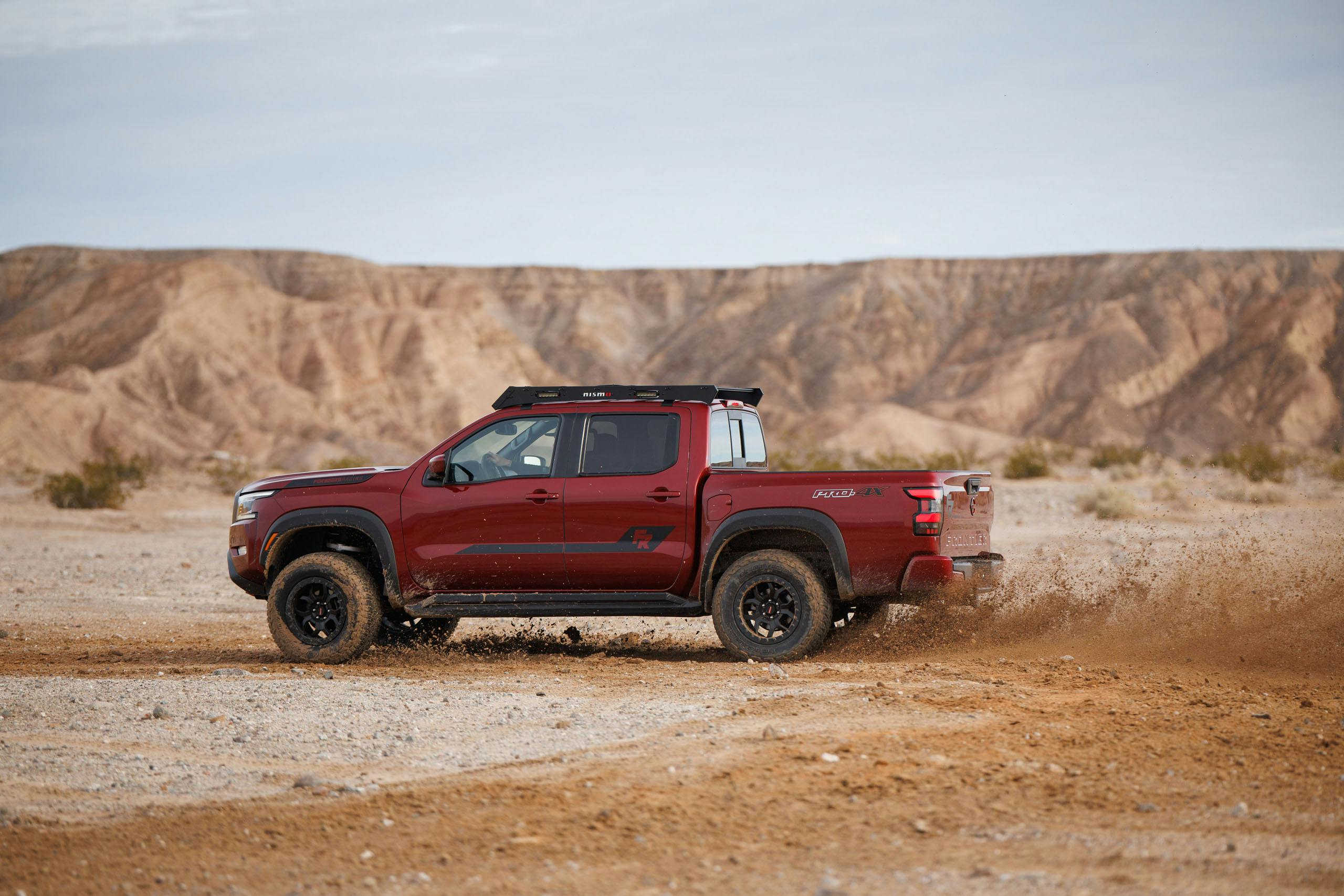 Nissan Frontier Forsberg Edition exterior demo truck side profile throwing dirt in desert
