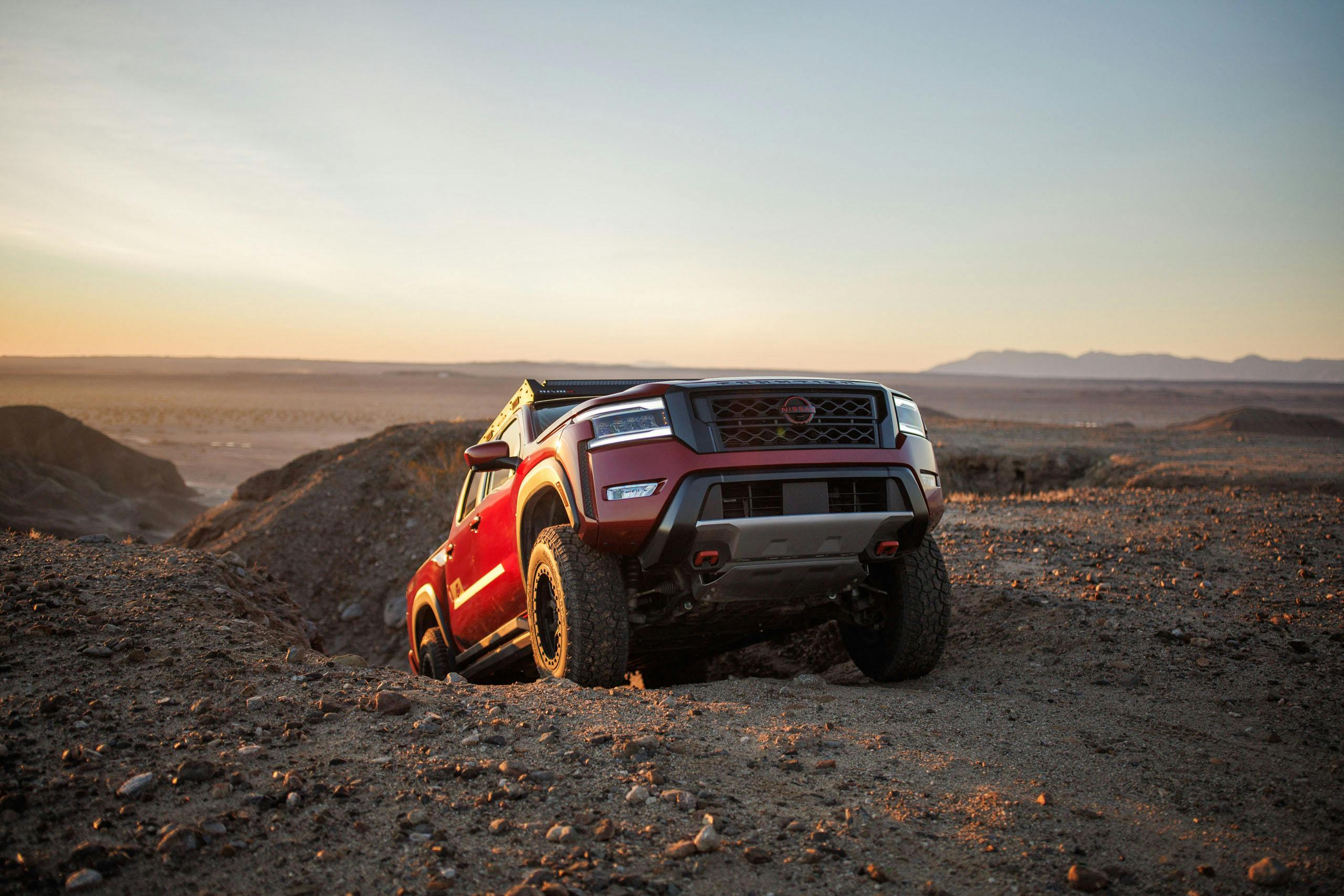 Nissan Frontier Forsberg Edition exterior demo truck front end climbing rocks in desert
