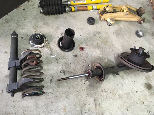 DIY Quick Struts parts disassembled on garage floor