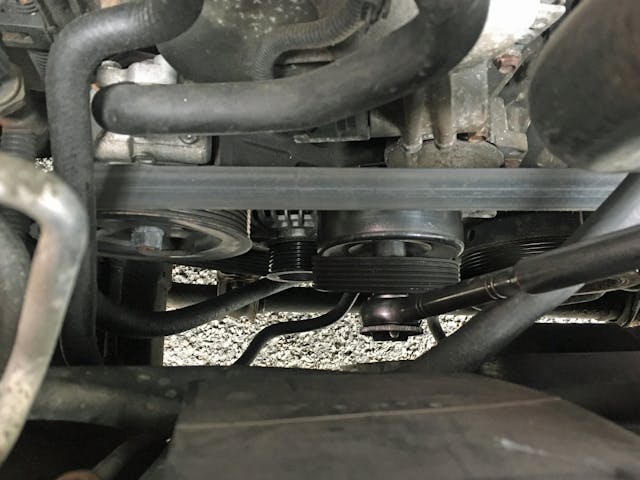 Nissan Armada engine bay old serpentine belt tensioner belt removal