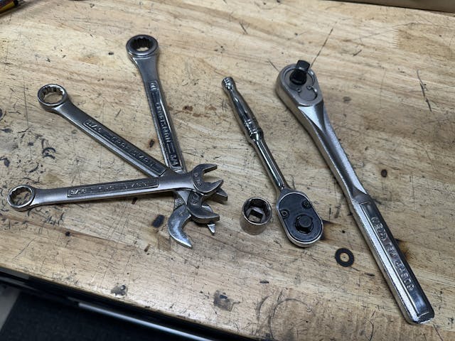 ratchet, socket, and wrenches, big ratchet on workbench